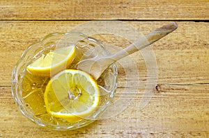 Sliced lemon in a glass plate filled with honey