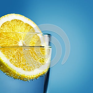 Sliced lemon in glass of water