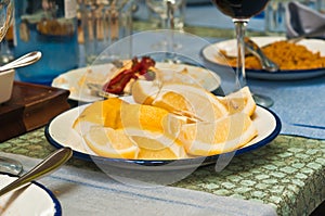 Sliced lemons on a white plate at a outdoor cafe in Madrid, Spain