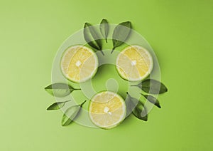 Sliced lime lemon with green leaf on green background