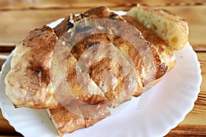 Sliced loaf of bread on white plate