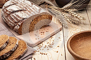 Sliced loaf of bread on wooden table