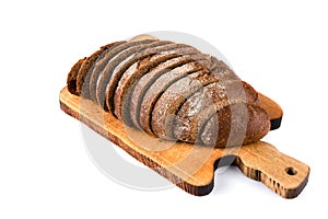 Sliced loaf of rye bread isolated on a white background. Bread slices on wooden cutting board viewed from above. Top view