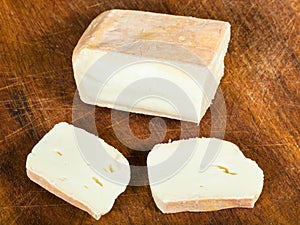 Sliced local italian Taleggio cheese on board