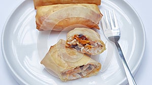 Sliced Lumpia Goreng Arranged on White Plate with Fork