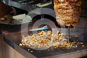 Sliced meat under a vertical spit