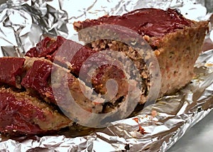 Sliced meatloaf warmed in aluminum foil