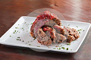 Sliced meatloaf on white plate