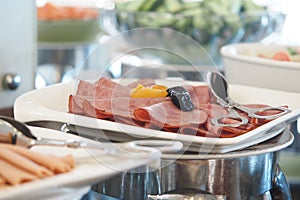 Sliced meats served on a tray at a buffet