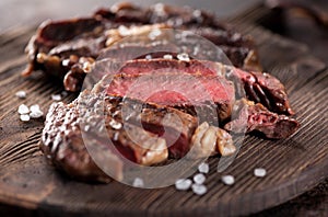 Sliced medium rare grilled beef steak ribeye close-up