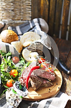 Sliced medium rare grilled Beef steak Ribeye on cutting board on