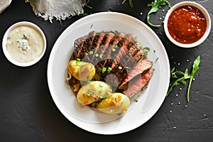 Sliced medium rare roast beef with potato