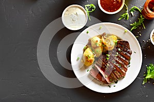 Sliced medium rare roast beef with potato