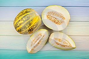 sliced melon on wood