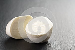 Sliced mozarella ball on slate background