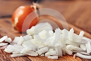 Sliced onion is on a wooden table. Close-up