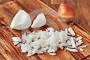 Sliced onion is on a wooden table. Close-up