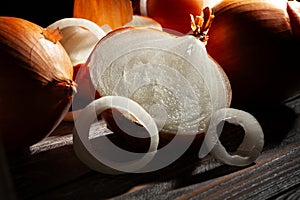 sliced onions on black wood