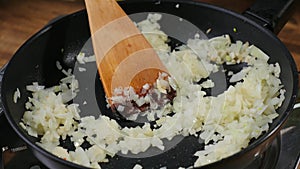 Sliced onions in a frying pan