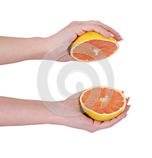 Sliced orange fruit in female hands isolated on white