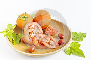 Sliced orange tomatoes are placed on a plate.