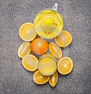Sliced oranges and juicer granit rustic background top view close up photo