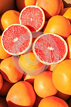 Sliced oranges on a pile of oranges