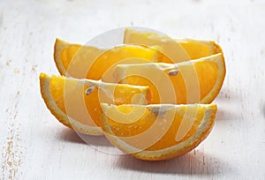 Sliced oranges white background wooden