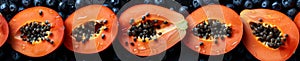 Sliced papaya and blueberries offering a visual and culinary feast on black background