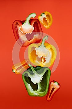 Sliced paprika on orange background. Cooking concept. Vegetables on color background.