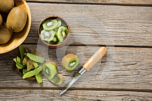 Sliced and pealed kiwi on wooden table