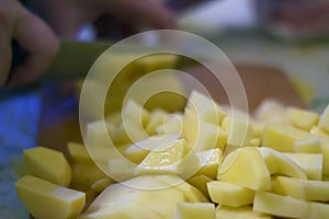 Sliced, peeled raw potatoes on a board. potato preparation process