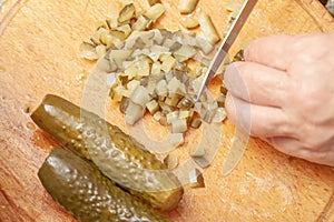 sliced pickle on the kitchen board. preparation of the ingredient for the dish. homemade cooking. slicing process