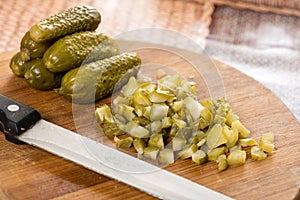 Sliced pickles on the kitchen wooden board