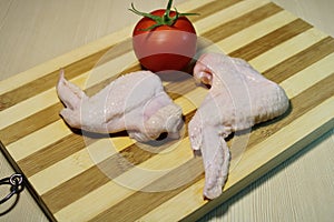 Sliced pieces of chicken on a wooden board.