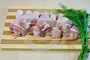 Sliced pieces of chicken on a wooden board.