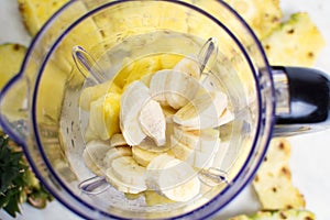 Sliced pineapple and banana in blender