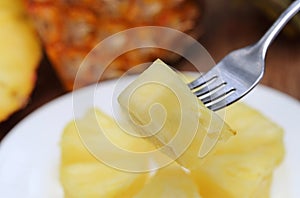 Sliced pineapple with fork