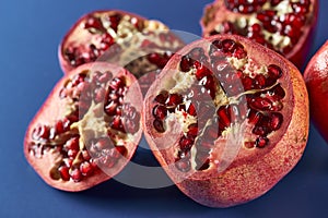 Sliced pomegranate on blue background