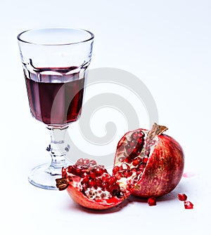 Sliced pomergranate and glass of juice