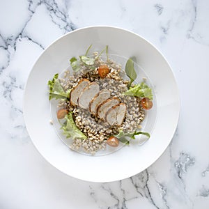 Sliced Pork Tenderloin and Wholegrain Salad on a Marble Background