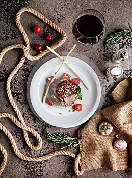 Sliced prime ribeye steak on black stone plate.