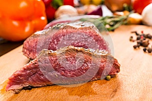 Sliced Rare Roast Beef on Wooden Cutting Board
