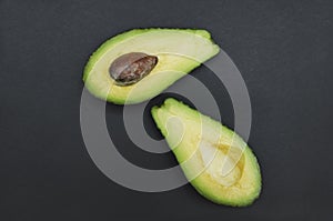 Sliced raw avocado on black background,closeup