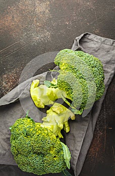 Sliced raw broccoli isolated on a dark background, top view, cop