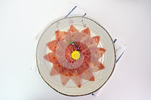 Sliced raw Maguro sashimi on ceramic dish