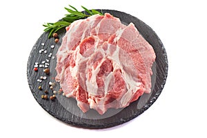 Sliced raw pork meat on stone plate, isolated on white background