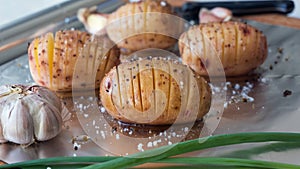 Sliced raw potatoes with spice on foil for baking