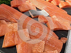 Sliced raw salmon or fresh salmon. Salmon fillets for sale at market displayed with a patchwork effect. Many fresh salmon fish