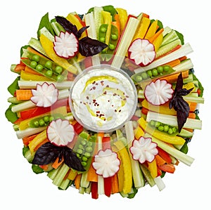 Sliced raw vegetables on a plate with white sauce. Colorful decor for a holiday table, buffet. Isolated on white. Top view